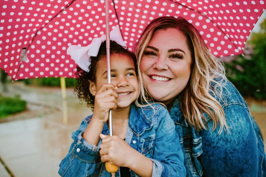 Woman with a child under an umbrella
